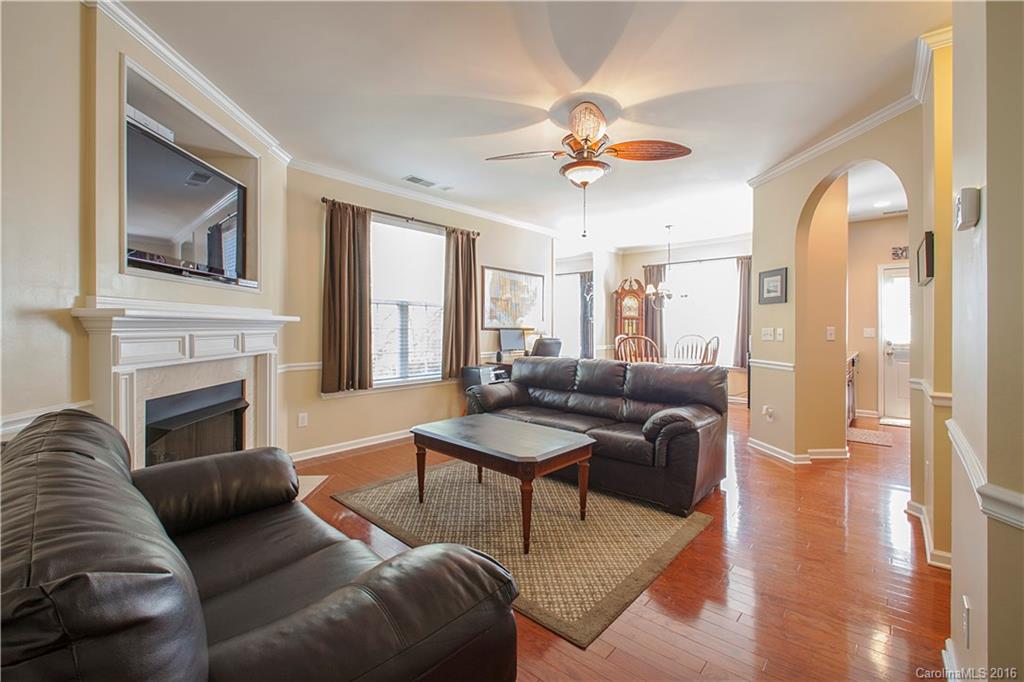 1903 Travertine Lane, Unit 1903 Fort Mill, SC 29708 - Photo 2 of 16 a living room with furniture a fireplace and a flat screen tv