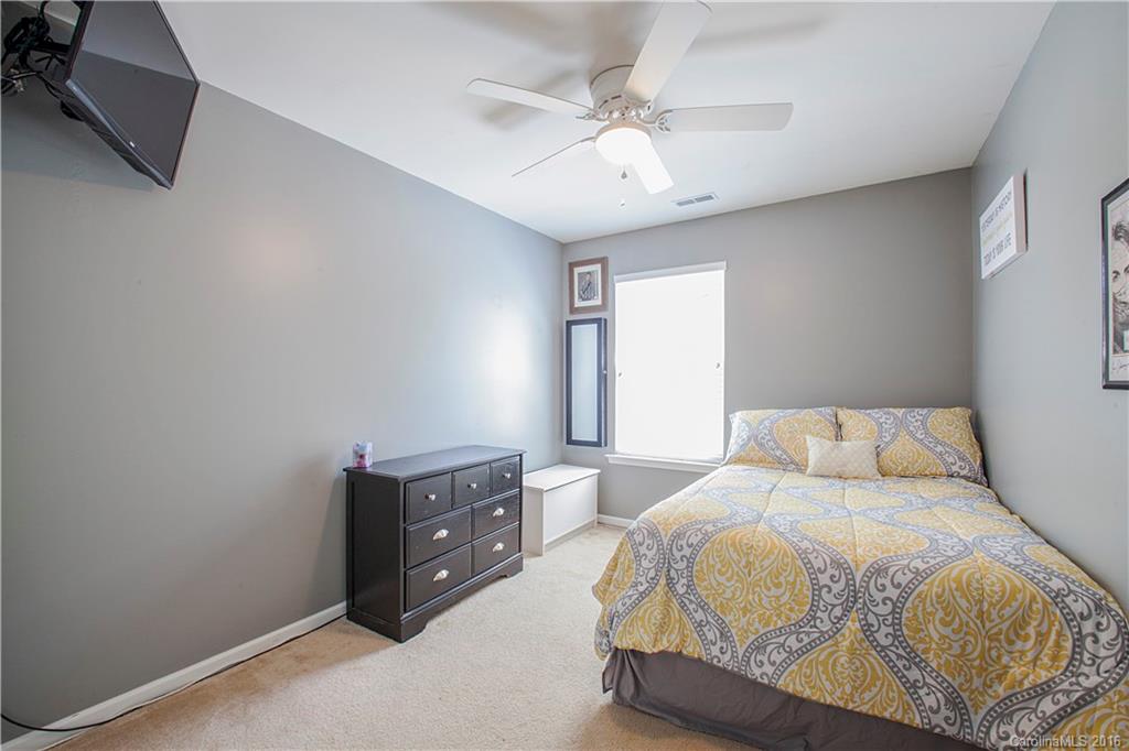1903 Travertine Lane, Unit 1903 Fort Mill, SC 29708 - Photo 13 of 16 a bedroom with a bed and a ceiling fan