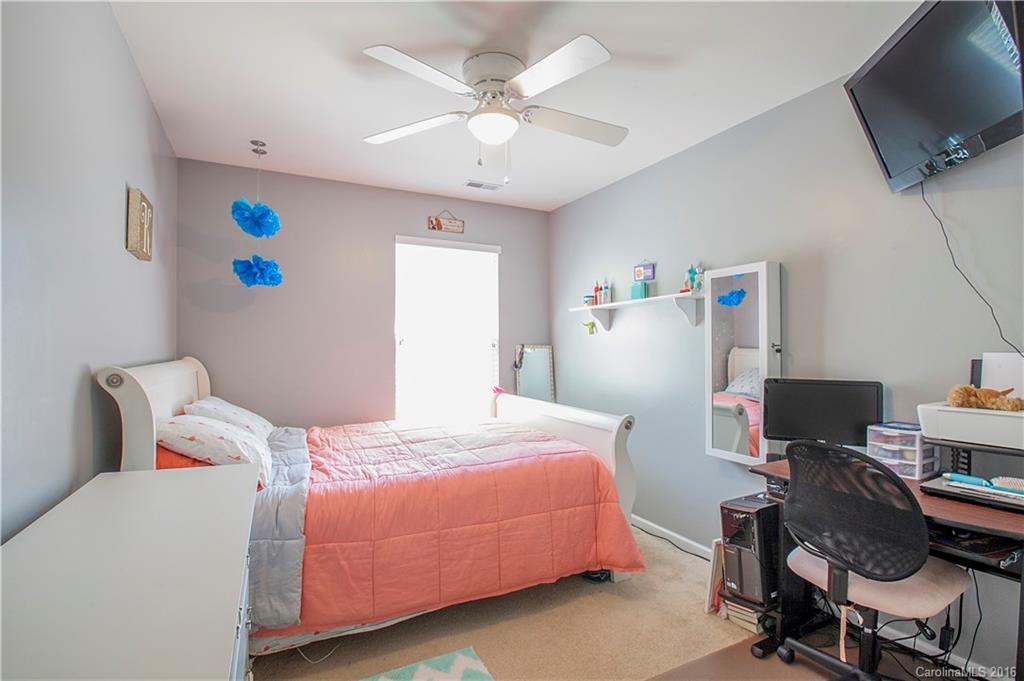 1903 Travertine Lane, Unit 1903 Fort Mill, SC 29708 - Photo 14 of 16 a bedroom with a bed and a flat screen tv