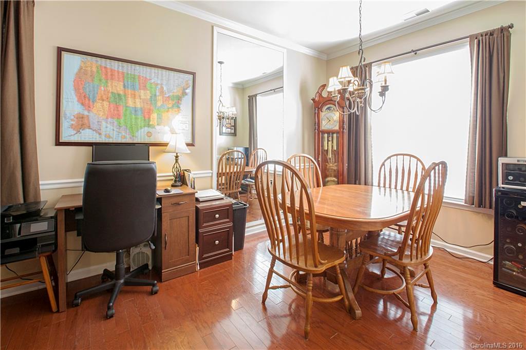 1903 Travertine Lane, Unit 1903 Fort Mill, SC 29708 - Photo 4 of 16 a dining room with furniture a window and wooden floor