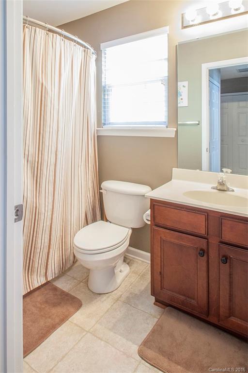 1903 Travertine Lane, Unit 1903 Fort Mill, SC 29708 - Photo 9 of 16 a bathroom with a toilet a sink and a mirror