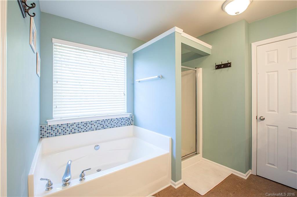 1903 Travertine Lane, Unit 1903 Fort Mill, SC 29708 - Photo 10 of 16 a bathroom with a bathtub and a shower