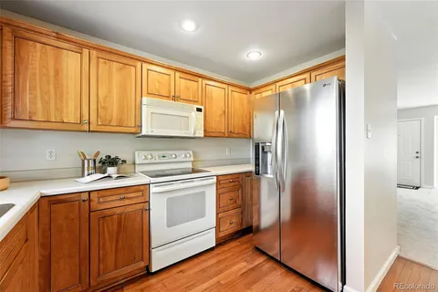 a kitchen with a refrigerator sink and cabinets