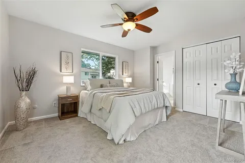 a spacious bedroom with a bed a window and a chandelier