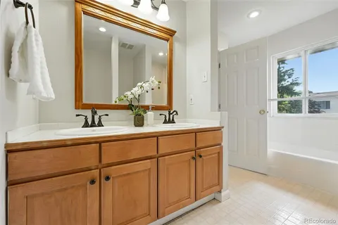 a bathroom with a double vanity sink and a mirror