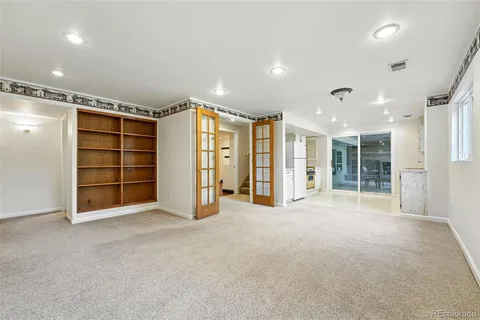 a view of an empty room with a closet and a window