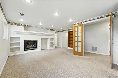 a view of a livingroom with an empty space and a fireplace