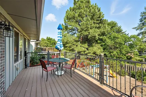 a view of a deck with table and chairs and wooden floor
