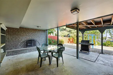 a dining room with furniture and a floor to ceiling window
