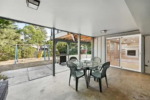 a dining room with furniture and large windows