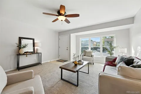 a living room with furniture and a large window