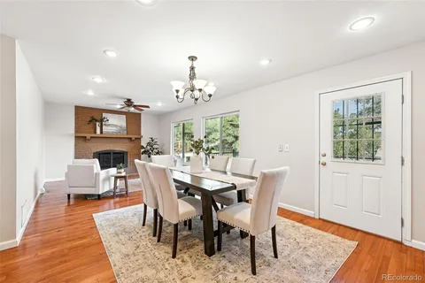 a view of a dining room with furniture a rug and wooden floor