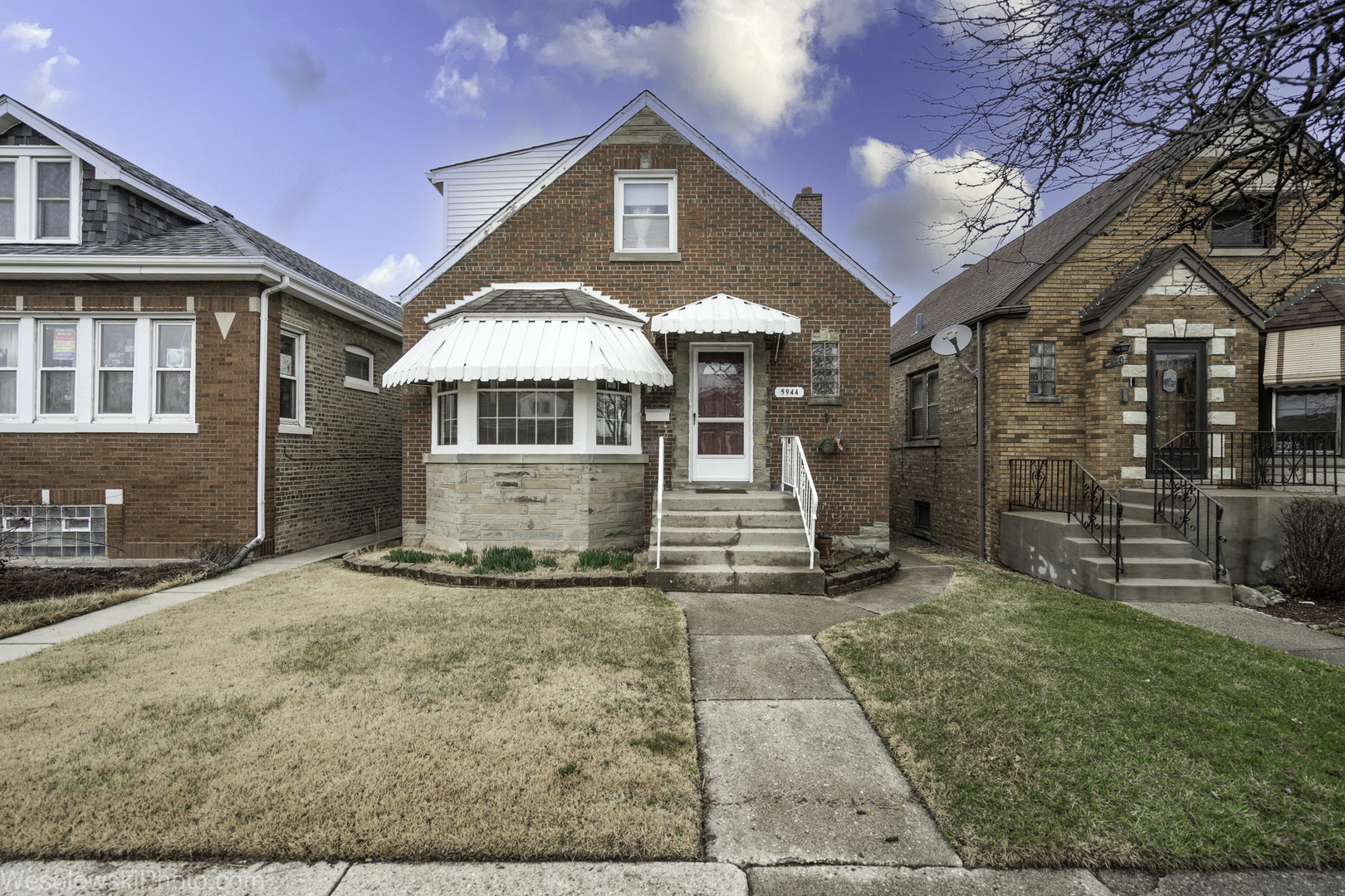 5944 West Foster Avenue Chicago, IL 60630 - Photo 1 of 21 a front view of a house with garden
