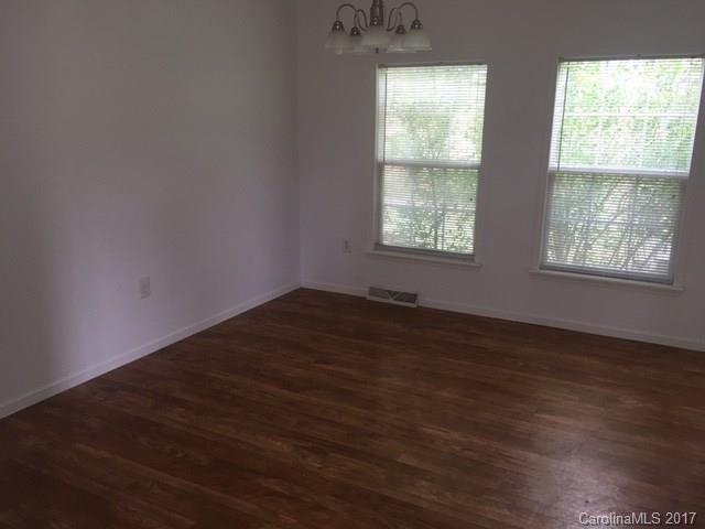 1903 Tom Williams Road Monroe, NC 28112 - Photo 6 of 22 an empty room with wooden floor and windows