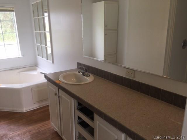 1903 Tom Williams Road Monroe, NC 28112 - Photo 9 of 22 a bathroom with a sink and a bathtub