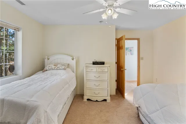 a bedroom with a bed and a ceiling fan