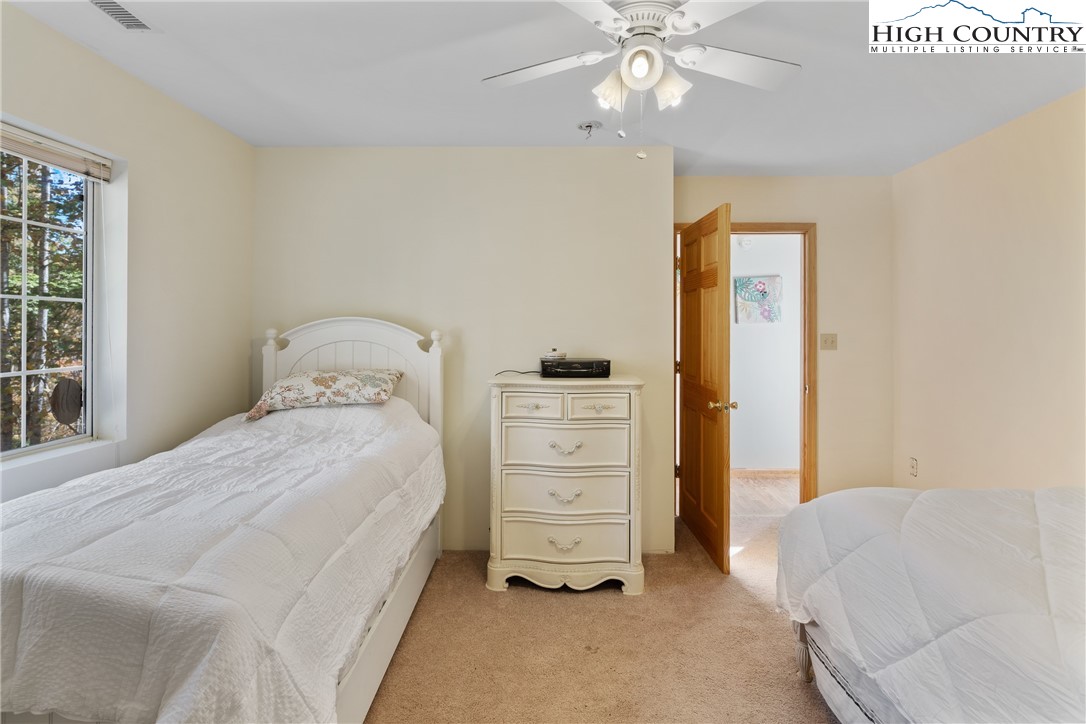 2161 Stone Mountain Road Vilas, NC 28692 - Photo 12 of 50 a bedroom with a bed and a ceiling fan