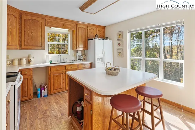 a kitchen with a table chairs sink and cabinets
