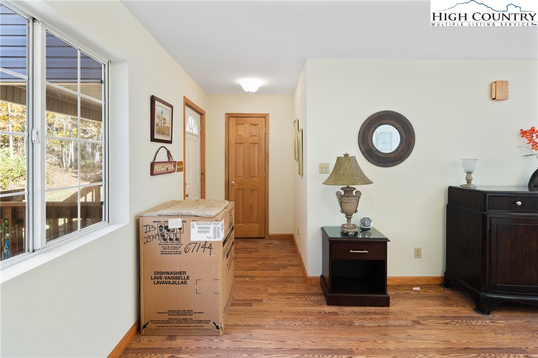 2161 Stone Mountain Road Vilas, NC 28692 - Photo 16 of 50 a living room with a table and a fireplace