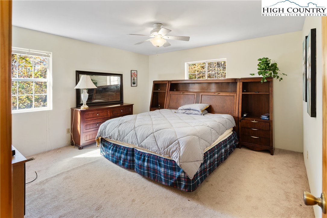 2161 Stone Mountain Road Vilas, NC 28692 - Photo 17 of 50 a bedroom with a bed table and dresser