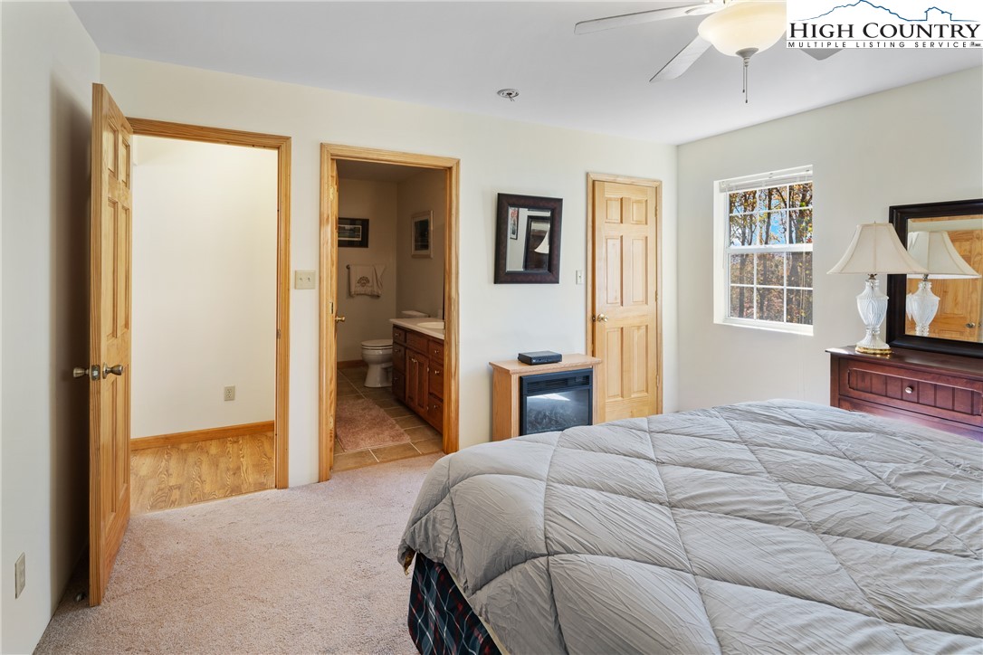 2161 Stone Mountain Road Vilas, NC 28692 - Photo 18 of 50 a bedroom with a bed and a view of kitchen