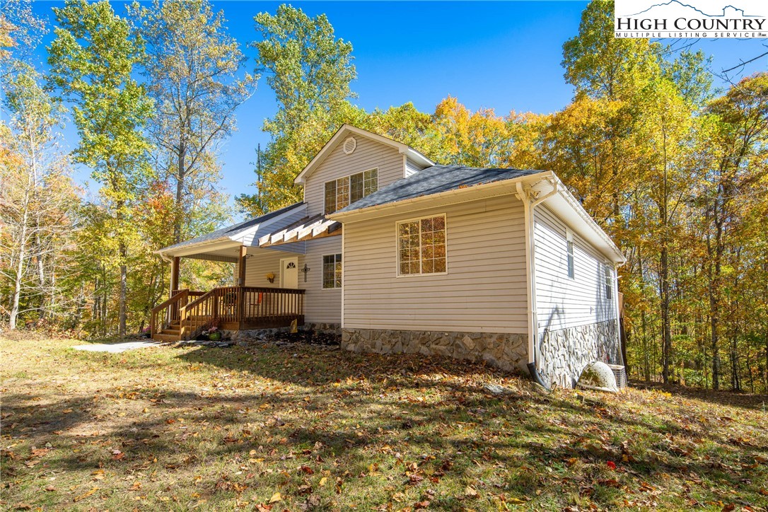 2161 Stone Mountain Road Vilas, NC 28692 - Photo 2 of 50 a backyard of a house with table and chairs