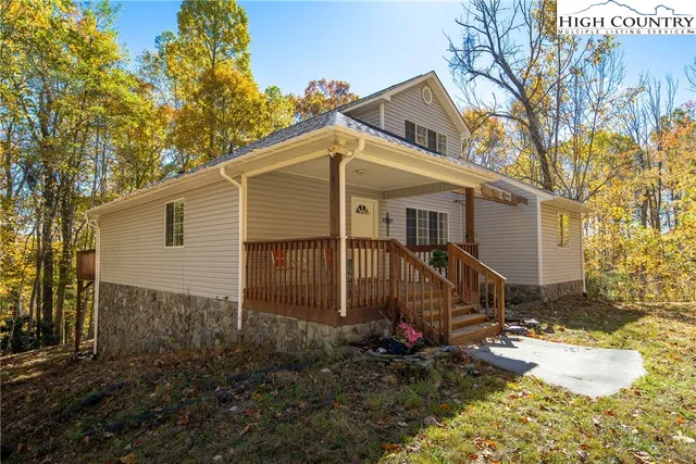a front view of a house with wooden deck
