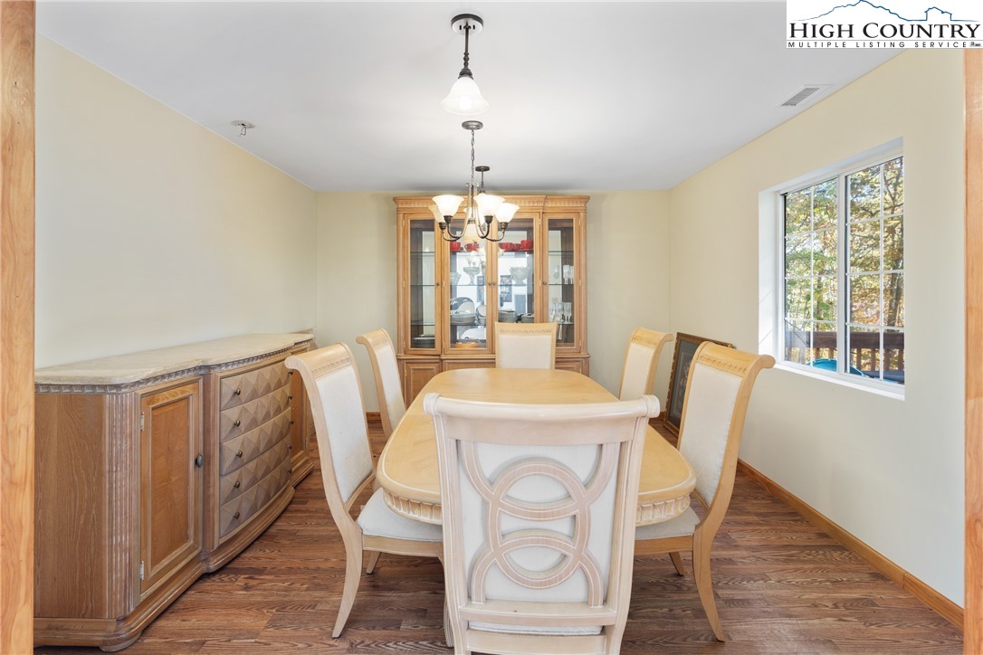 2161 Stone Mountain Road Vilas, NC 28692 - Photo 8 of 50 a view of a dining room with furniture window and wooden floor
