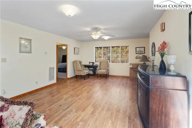 a bedroom with furniture and wooden floor