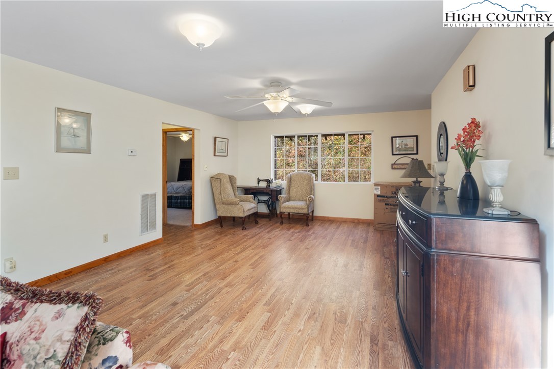 2161 Stone Mountain Road Vilas, NC 28692 - Photo 10 of 50 a bedroom with furniture and wooden floor