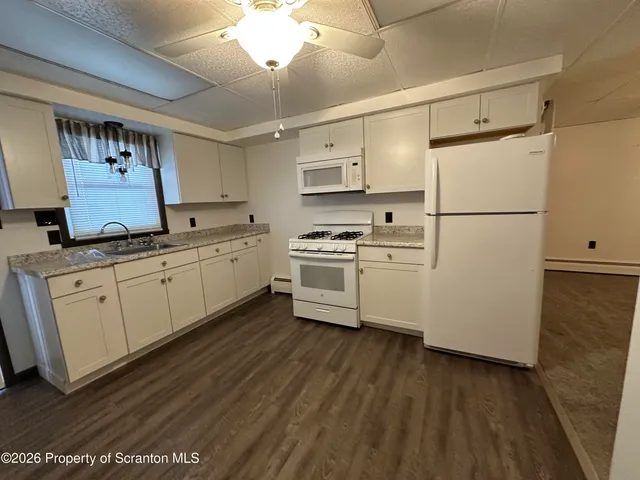 a kitchen with stainless steel appliances a refrigerator sink and cabinets