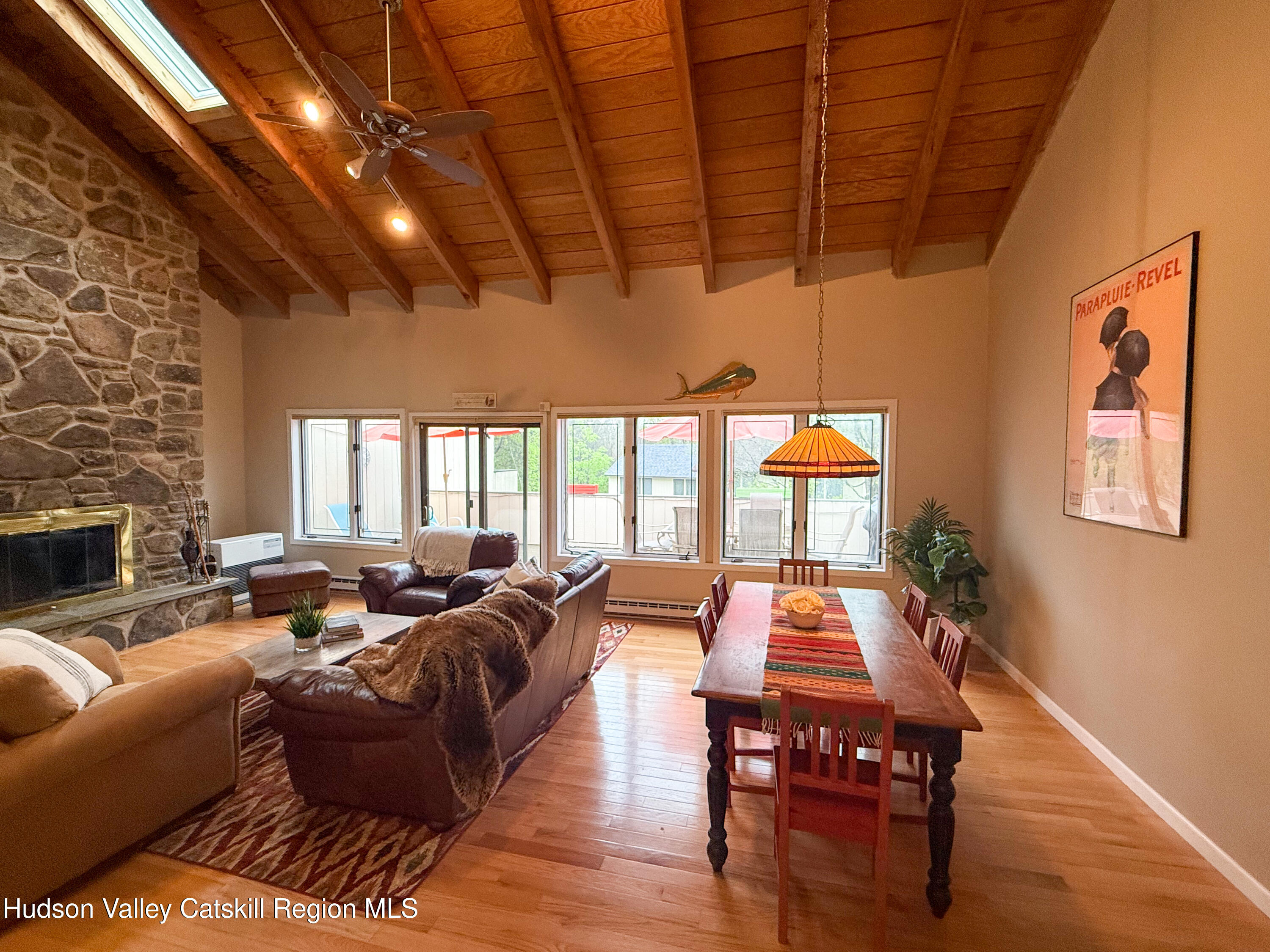 300 Pines Drive, Unit 446 Roxbury, NY 12421 - Photo 12 of 49 a living room with furniture a fireplace and wooden floor