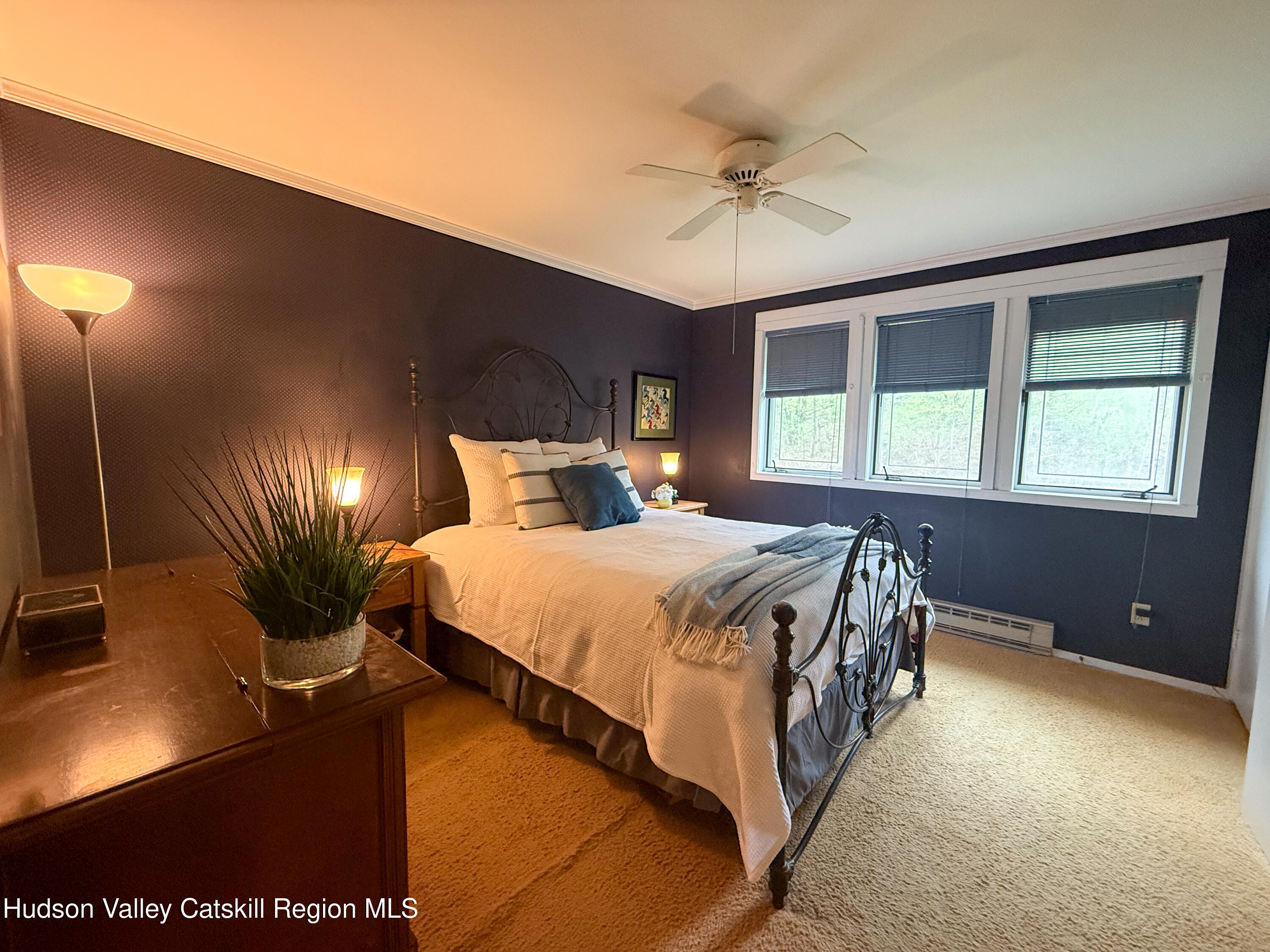300 Pines Drive, Unit 446 Roxbury, NY 12421 - Photo 23 of 49 a bedroom with a bed and a chandelier