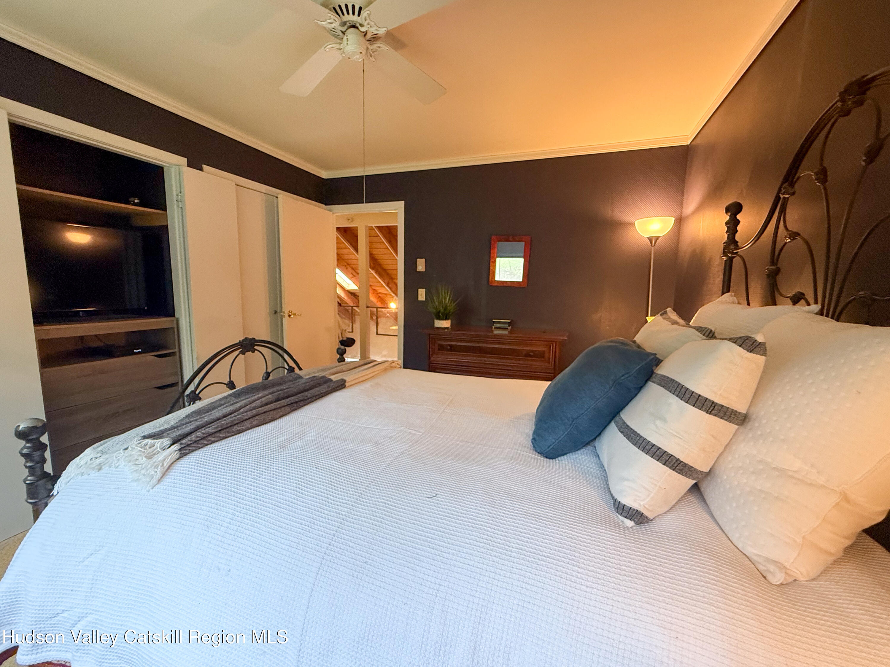 300 Pines Drive, Unit 446 Roxbury, NY 12421 - Photo 24 of 49 a bedroom with a bed and a flat tv screen on dresser