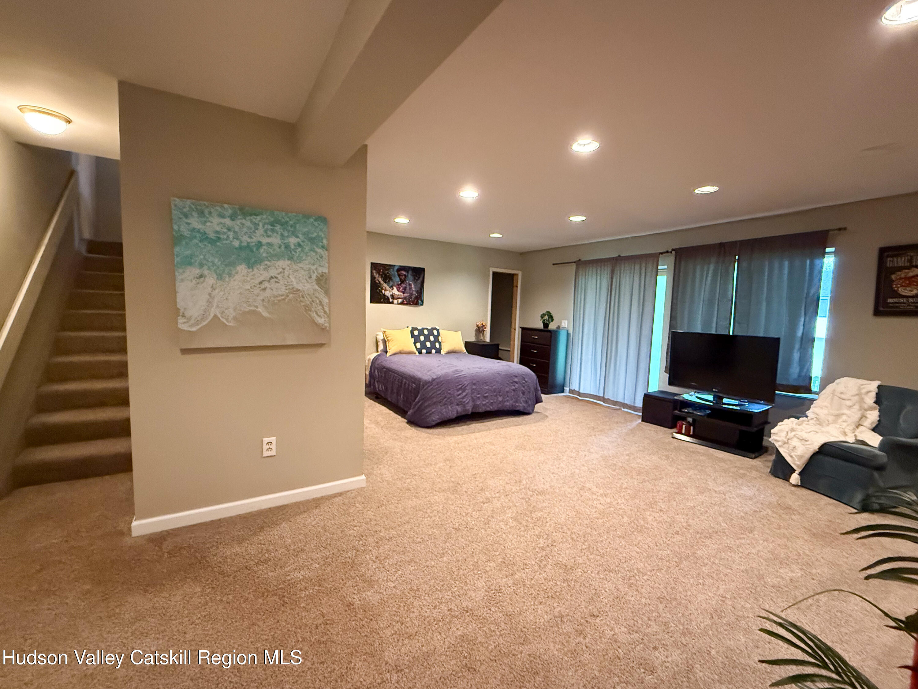 300 Pines Drive, Unit 446 Roxbury, NY 12421 - Photo 34 of 49 a living room with furniture a flat screen tv and a refrigerator
