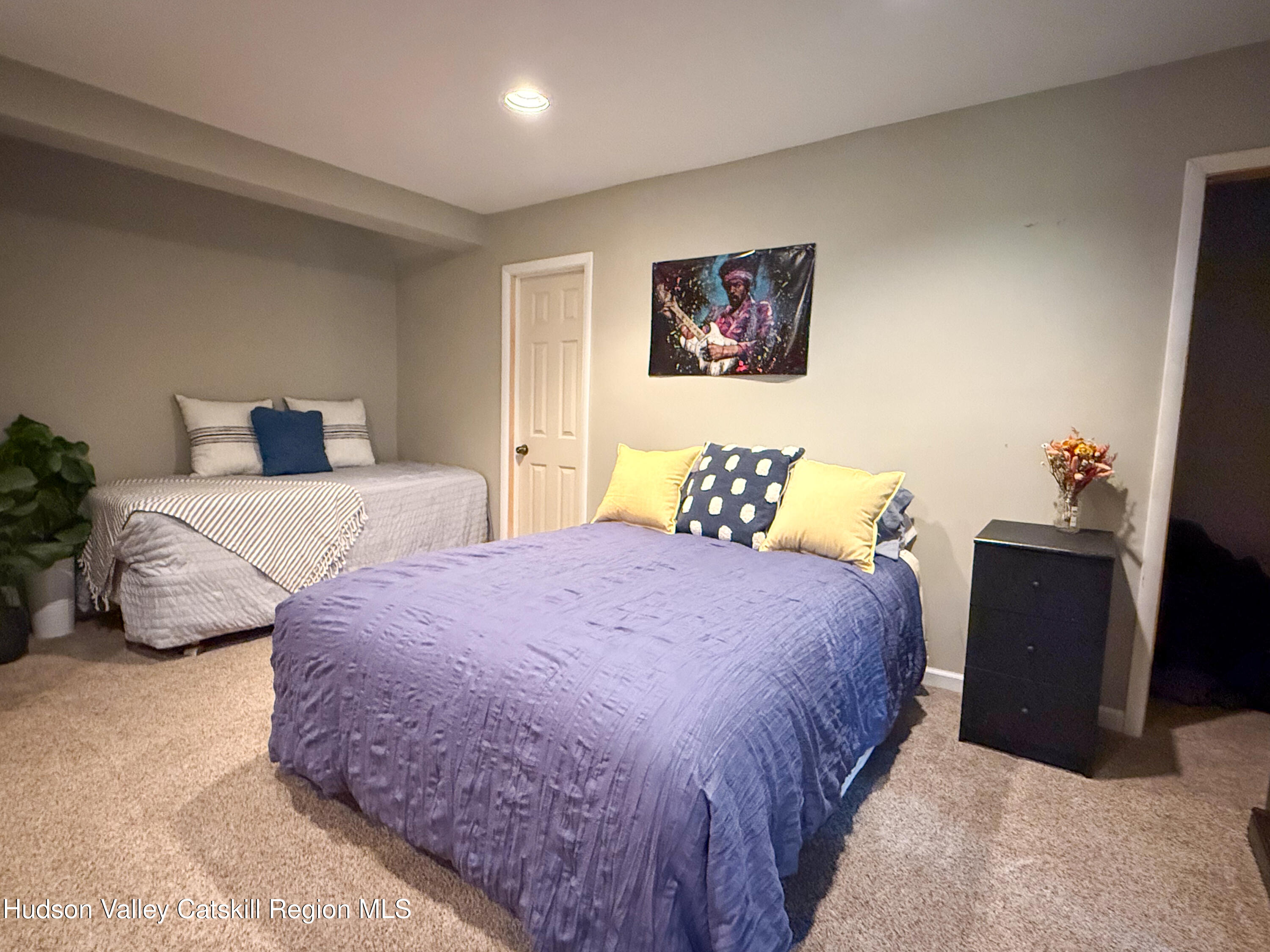 300 Pines Drive, Unit 446 Roxbury, NY 12421 - Photo 35 of 49 a bedroom with bed and a potted plant on dresser