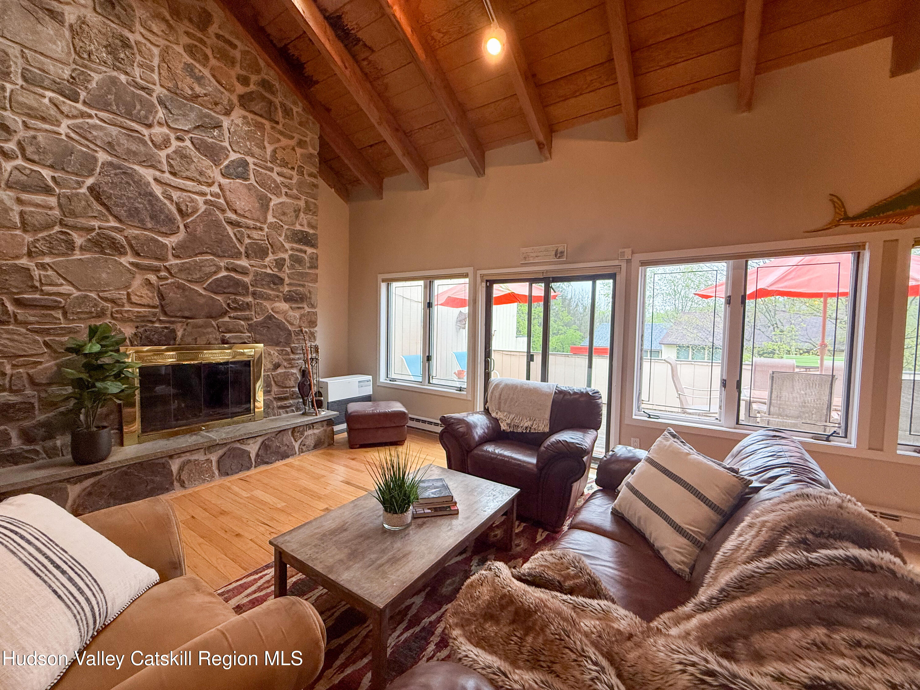 300 Pines Drive, Unit 446 Roxbury, NY 12421 - Photo 10 of 49 a living room with furniture large window and a fireplace