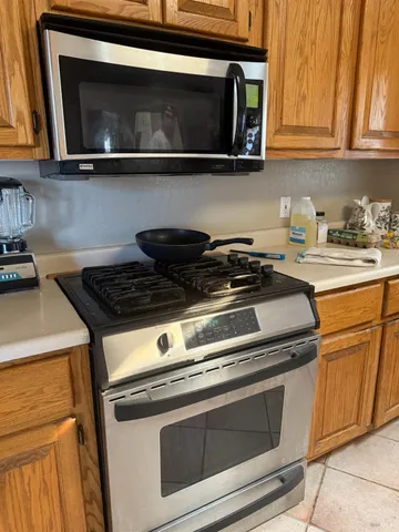 a stove top oven sitting inside of a kitchen