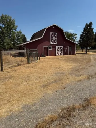 a view of a wooden house with a yard