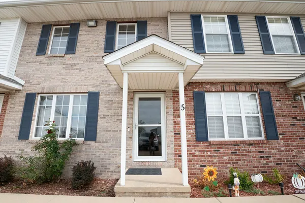 a view of a brick house with large windows