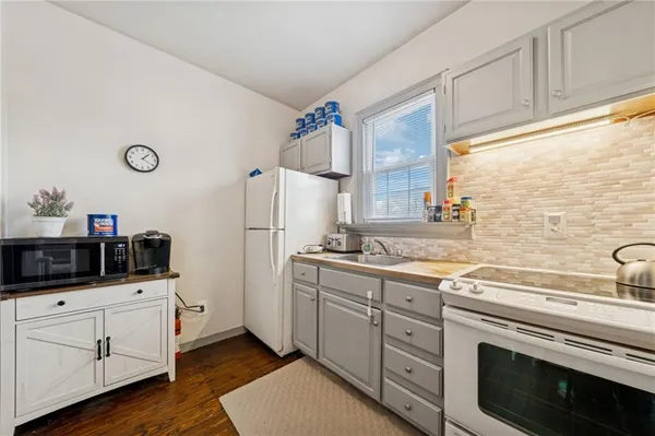 a kitchen with cabinets appliances and a counter space