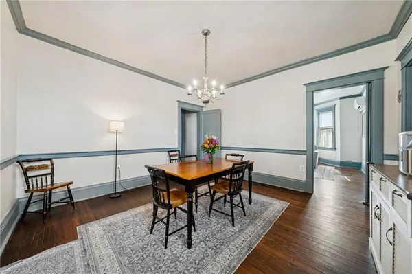 a view of a dining room with furniture and wooden floor