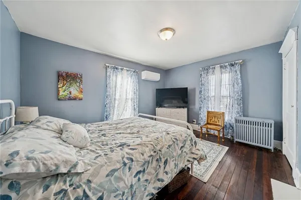 a bedroom with a bed and a tv