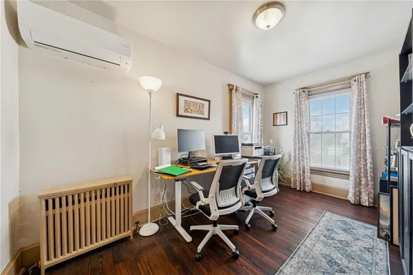 a view of a dining room with furniture and a window