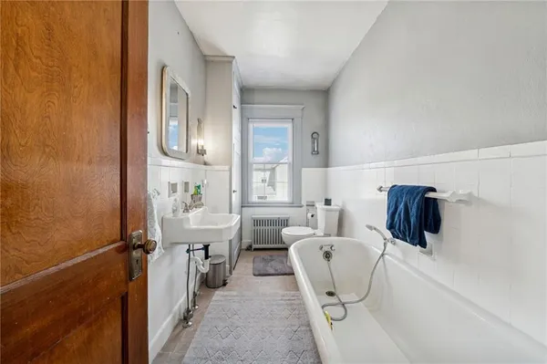 a living room with furniture a table and white doors