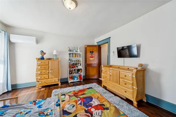 a bedroom with a bed and flat screen tv