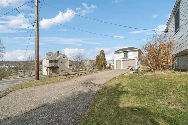 a view of a house with a yard and garage