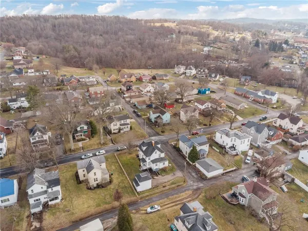 an aerial view of residential house with parking