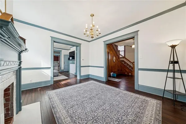 a living room with furniture and a chandelier