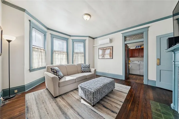 a living room with furniture and a wooden floor